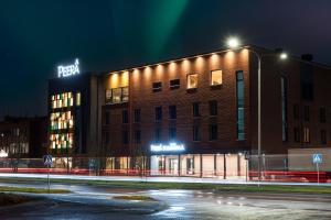 a building with a sign on top of it at night at Hotelli Sodankylä in Sodankylä