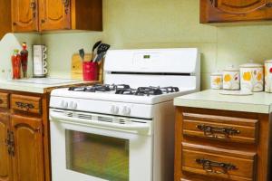 a white stove top oven in a kitchen at Big Comfy Home with King & Queen Beds in Lafayette