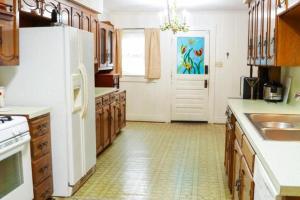 a kitchen with a white refrigerator and a sink at Big Comfy Home with King & Queen Beds in Lafayette