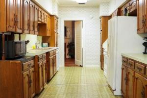 a kitchen with wooden cabinets and a white refrigerator at Big Comfy Home with King & Queen Beds in Lafayette
