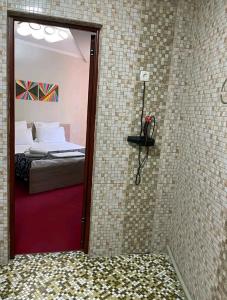 a bathroom with a shower with a bed and a mirror at КзО in Shymkent