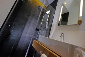 a bathroom with a shower and a sink at Hotel Vista Allegra in Ischgl