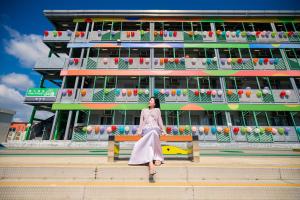 香港にあるRunway 1331 - Enlightの建物の前のベンチに座っている女性