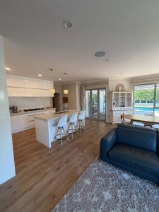 a kitchen and living room with a couch and a table at Millwater Retreat in Silverdale