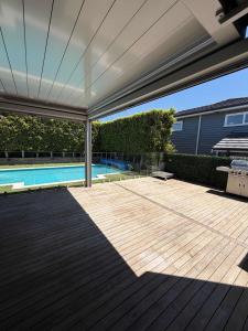 a covered patio with a swimming pool and a swimming pool at Millwater Retreat in Silverdale