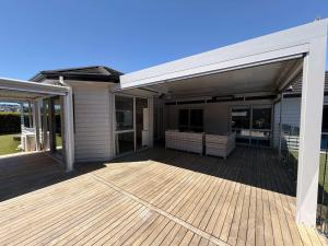 a house with a large deck with sliding glass doors at Millwater Retreat in Silverdale +16 photos