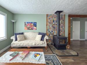 a living room with a couch and a wood stove at The Garden Gate in R Corner