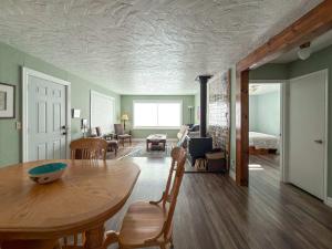 a living room with a table and a bedroom at The Garden Gate in R Corner