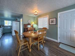 a kitchen and dining room with a table and chairs at The Garden Gate in R Corner