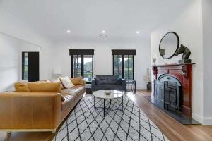 a living room with a couch and a fireplace at Fallenwood - Vineyard Escape in Orange