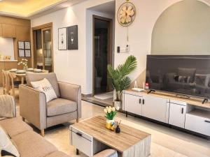 a living room with a large tv and a couch at R&F Princess Cove 2BR Sea View JB CIQ Spacious in Johor Bahru