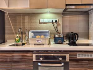 a kitchen with a sink and a counter top at R&F Princess Cove Studio Sea Front CIQ-Singapore in Johor Bahru