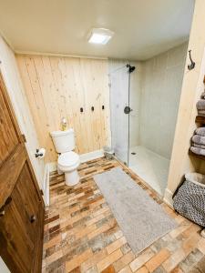 a bathroom with a toilet and a shower at Moki Pines Chalet - Stylish Stay Among the Pines in Flagstaff +14 photos