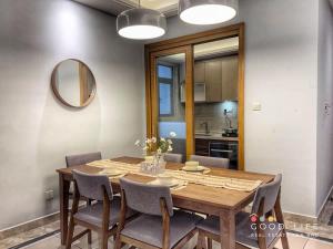 a dining room table with chairs and a mirror at R&F Princess Cove 3BR JB Central CIQ Spacious in Johor Bahru
