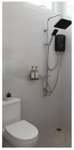 a white bathroom with a toilet and a shower at Vapanakhaw Ubon in Ubon Ratchathani +3 photos