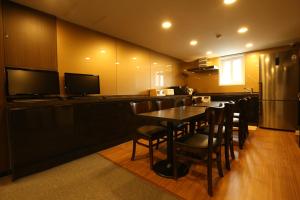 a kitchen with a bar with a table and chairs at Tripstay Myeongdong in Seoul