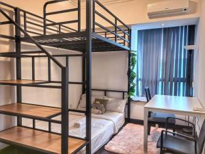 a room with a bunk bed and a desk at R&F Princess Cove 3BR CozyDesign JB Central CIQ in Johor Bahru