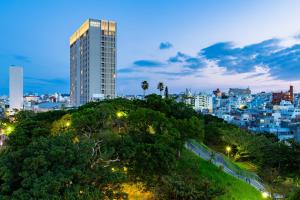 a city skyline at night with a tall building at Hyatt Regency Naha, Okinawa in Naha