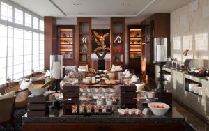 a lobby of a hotel with a counter with food at Hyatt Regency Naha, Okinawa in Naha