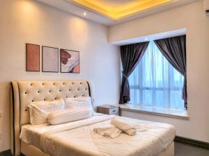 a bedroom with a large bed with a large window at R&F Princess Cove 3BR Sea View Bathtub JB Malls in Johor Bahru