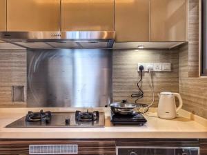 a kitchen with a stove with a pot on it at R&F Princess Cove 3BR Sea View Bathtub JB Malls in Johor Bahru +15 photos