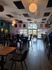 a dining room with tables and chairs and lights at Mobil-hom in Lège-Cap-Ferret