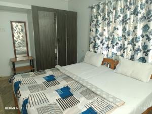 a bedroom with two beds and a window at Jacinta's - By the beach - Cruz's place in Calangute