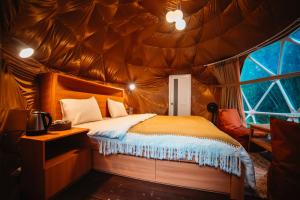a bedroom with a bed in a tent at Pelaga Eco Park in Patjung