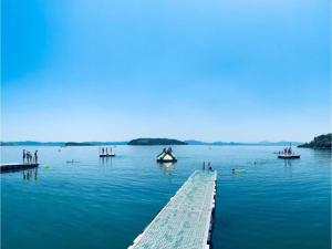 a group of people in the water near a dock at Nice apartment in Tuoro sul Trasimeno with pool in Tuoro sul Trasimeno