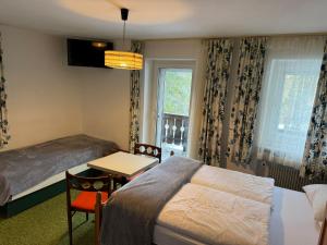 a bedroom with a bed and a desk and a table at Gassermühle - Studio Appartments in Eggen