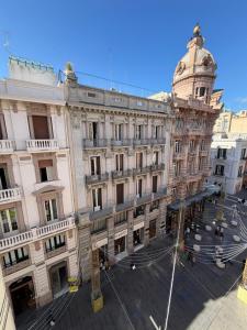 ein großes Gebäude mit einem Uhrturm in einer Stadt in der Unterkunft Sparano Palace - Luxury Maison in Bari