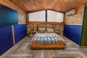 a bed in a room with a wooden ceiling at ANKA RESİDENCE KIZıLAY in Ankara