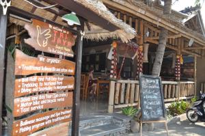 a restaurant with a sign in front of it at Trijaya Guest House Pemuteran in Pemuteran +144 photos