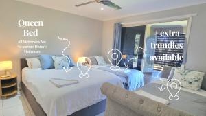 a room with two beds and a chair in it at Hinterland Hideaway Farm Stay in Wolvi