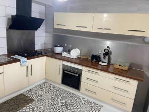 a kitchen with white cabinets and a counter top at La kazolie in Sainte-Rose