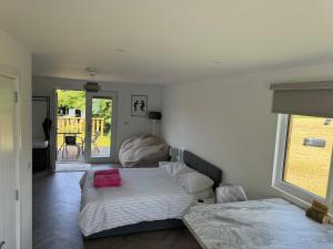 a bedroom with a bed with a pink object on it at Luxury Beachfront Lodge in Hest Bank