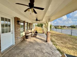 a porch with a ceiling fan on a house at Katy Getaway - Relaxed 3BR Home with Serene Views in Hoffpauir Airport