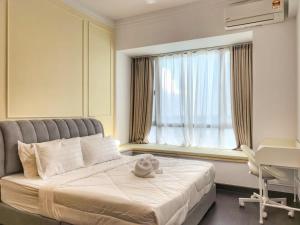 a bedroom with a bed with a stuffed animal on it at R&F Princess Cove 2BR Sea View JB-SG CIQ Malls in Johor Bahru