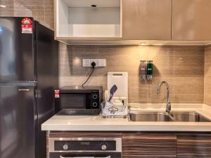 a kitchen with a sink and a microwave at R&F Princess Cove 2BR Sea View JB-SG CIQ Malls in Johor Bahru +17 photos