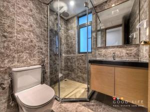 a bathroom with a toilet and a sink and a mirror at Queen Room R&F Princess Cove Shared Common Space in Johor Bahru