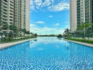 a large blue swimming pool between two tall buildings at Queen Room R&F Princess Cove Shared Common Space in Johor Bahru