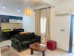 a living room with a couch and a table at Cata Apartment Hotel And Spa in Ikeja