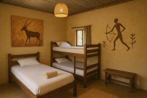 a room with two bunk beds and a painting on the wall at Bushman Spoor Backpackers in Soweto