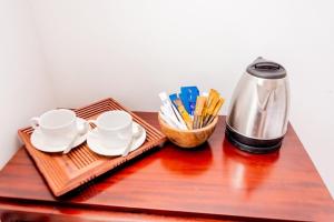 a table with a tray with two cups and a thermos at Villa TIS in Galle