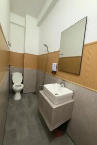 a bathroom with a sink and a toilet and a mirror at Khách Sạn Anh Anh in Ho Chi Minh City