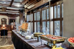 a buffet line with food on it in a restaurant at Days Inn & Suites by Wyndham West Edmonton in Edmonton