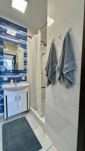 a bathroom with a sink and a shower at Апартаменти біля Фортеці in Kamianets-Podilskyi