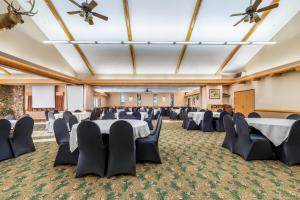 a banquet hall with tables and chairs in a room at AmericInn by Wyndham Chamberlain Conference Center in Chamberlain +50 photos