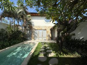 サヌールにあるMaison Boheme Modern Apartment & Villa with Pool in Sanurのヴィラ(家の前にスイミングプール付)