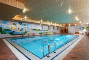 a large swimming pool in a large building at Sport Hotel Pampeago in Tesero